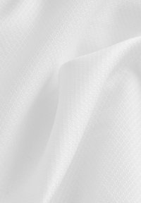Tessuto bianco intrecciato con una superficie liscia, caratterizzato da un delicato motivo a quadri e una morbida caduta. La superficie è pulita e senza imperfezioni.