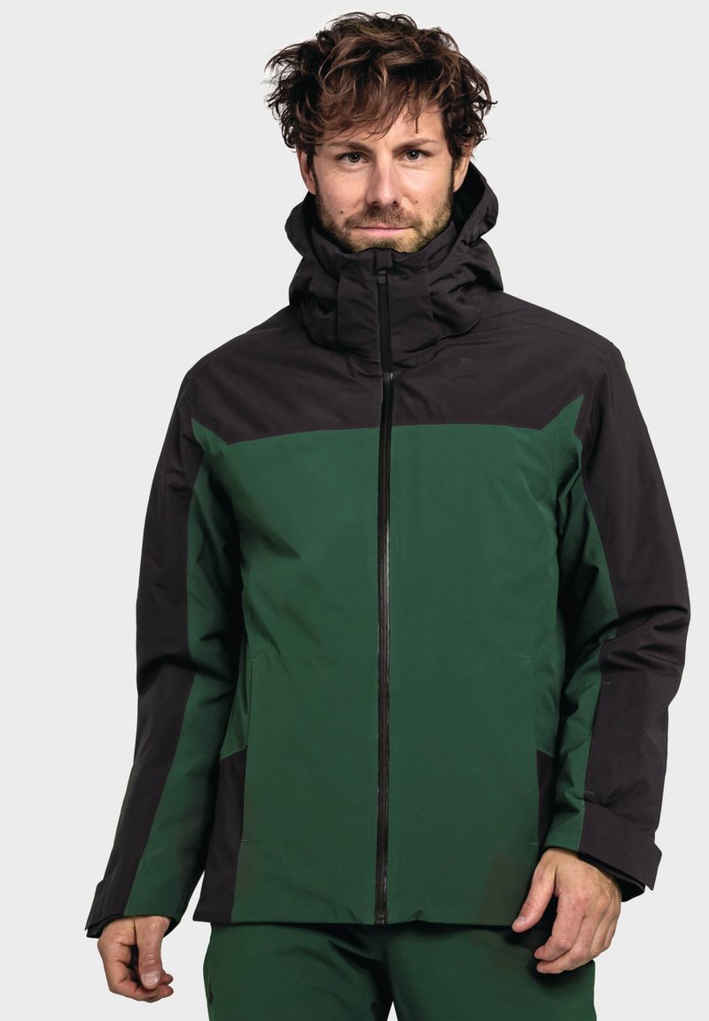 Grüne und schwarze wasserdichte Jacke mit hohem Kragen, durchgehendem Reißverschluss und Seitentaschen; zeichnet sich durch eine strukturierte Oberfläche und kontrastierende Farbblöcke aus.