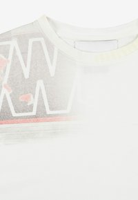 Biała bawełniana koszulka z gradientowym wzorem, dużymi szarymi literami i delikatnymi różowymi akcentami, okrągłym dekoltem i miękką fakturą.