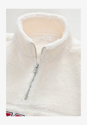 Polovica zips pulóver z flísu v off-white farbe, s strieborným zipsom, textúrovanou tkaninou a značkovým štítkom vo vnútri goliera.