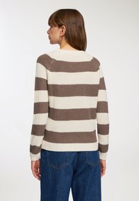 Maglione lavorato a maglia con spesse righe orizzontali in crema e marrone, con una finitura texturizzata e maniche lunghe. Design a vestibilità rilassata.
