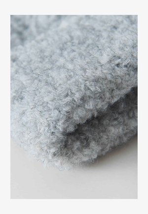 Soft gray knitted fabric featuring a textured, looped pattern. The material appears fuzzy with a slightly irregular surface.