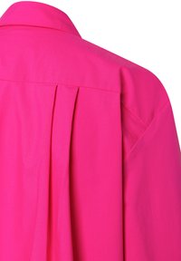 Fuchsia shirt with a collar, featuring a back pleat and smooth texture. Fabric is lightweight, displaying a solid color without patterns.