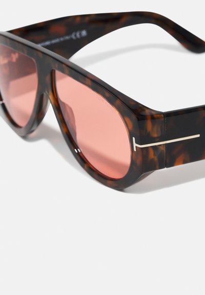 Tortoiseshell sunglasses with wide rectangular frames, pink tinted lenses, and a minimalistic silver accent on the temple hinge.