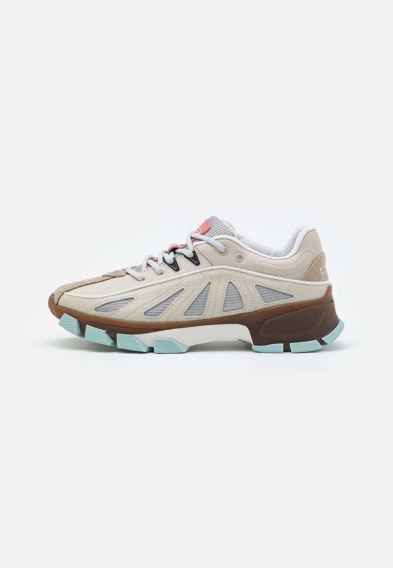 Basket beige et bleu clair avec semelle épaisse marron, panneaux latéraux en mesh, lacets blancs et col rembourré, conçue pour une utilisation extérieure ou décontractée.