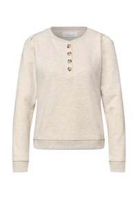 Jasnobeżowa bluza wykonana z miękkiego materiału, z okrągłym dekoltem, długimi rękawami i pięcioma guzikami z przodu. Mankiety i dół bluzy wykończone ściągaczem.