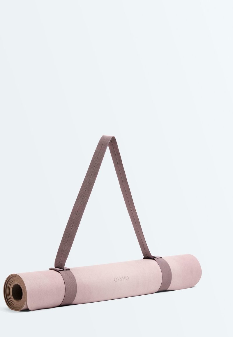 Roll-up pink yoga mat with brown carrying straps and "OYSHO" logo, set against a plain light background.
