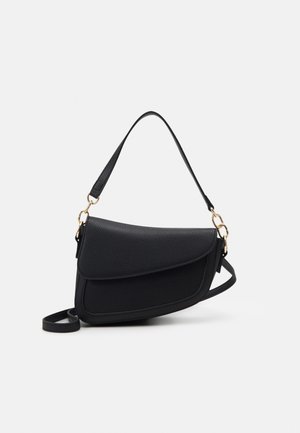 Black textured leather shoulder bag with curved flap, gold hardware, and adjustable strap on a white background.