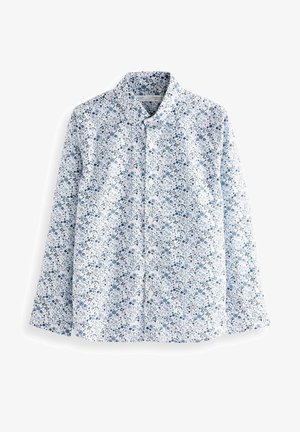 Chemise à manches longues boutonnée avec une base blanche et un motif floral bleu, avec un col classique et des boutons sur le devant.