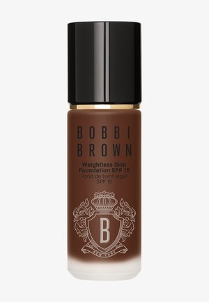 Fond de teint Bobbi Brown Weightless Skin SPF 15 en teinte marron foncé avec un bouchon noir et un emblème décoratif sur un flacon en verre dépoli.