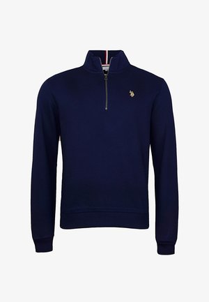 Námornícky modrý fleecový pulóver s polovičným zipsom, rebrovanými manžetami a lemom, ktorý má malú vyšitú nášivku na hrudi. Mäkká textúra.