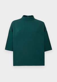 Top corto a maniche corte di colore teal con collo a lupetto, dotato di chiusura con zip sul retro. Realizzato in tessuto morbido con una vestibilità comoda.