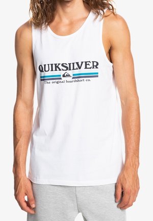 Man wearing white sleeveless tank top with "QUIKSILVER" text and logo above blue stripes, paired with light gray shorts.