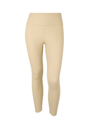 Leggings beiges en tissu extensible, dotés d'une taille haute et d'une texture lisse, conçus pour le confort et la flexibilité.
