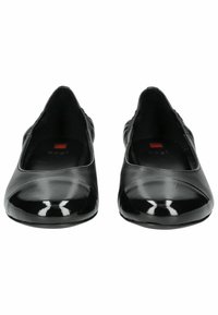 Svarta ballerina-skor med en slät läderövre och glansig lackad tå. Har en vadderad innersula och en rundad form.