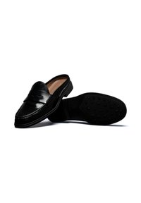 Black leather loafers with a raised seam, slip-on design, rubber sole featuring rounded traction dots, and a smooth interior lining.