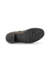 Semelle extérieure en caoutchouc noir avec un motif de grip texturé, présentant une légère élévation au niveau du talon et un logo embossé près du talon.