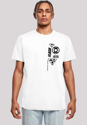 White cotton t-shirt featuring black printed logos and text, including superhero symbols and names, arranged vertically on one side.