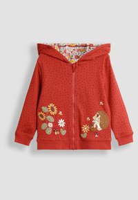 Felpa rossa con zip e cappuccio, caratterizzata da una texture a pois. Presenta ricami di fiori e ricci sul davanti, foderata con un motivo floreale colorato.