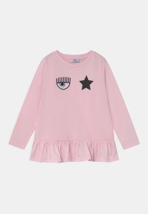 Pink long-sleeve t-shirt featuring an eye and star design on the front, with a ruffled hem and made from soft cotton material.