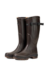Brown rubber knee-high boots with a textured finish, reinforced toe, and adjustable strap feature. Grooved sole for improved traction.