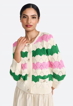Knit cardigan featuring a cream base with zigzag patterns in pink and green. It has a round neckline, button front, and ribbed cuffs.
