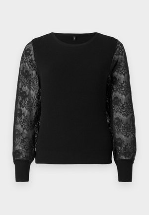 Jersey negro de punto con textura acanalada y mangas largas de encaje con patrones florales. Cuello redondo y puños ajustados.