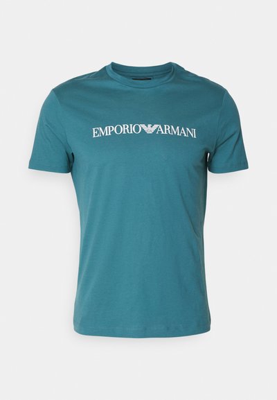 Turkio medvilnės marškinėliai su apvalia kaklo išpjova ir trumpomis rankovėmis, ant krūtinės esantis baltas "Emporio Armani" logotipas. Lygi tekstūra.