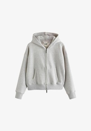 Sivá zip-up kapuca iz mehkega materiala, ki ima kapuco, sprednje žepke, rebraste manšete in obseg. Preprost, oversized dizajn z minimalnim blagovnim znakom.