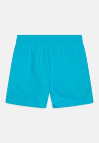 Bright blue elastic waistband shorts laid flat, showing the back side with center seam stitching.