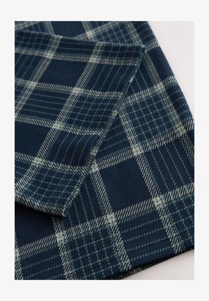 Tengerészkék kockás szövet zöld és bézs díszítéssel. Változó méretű négyzetekből és finom vonalakból álló kockás mintázat. Puha tapintású.