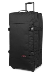 Borsa da viaggio con ruote nere, angoli rinforzati, cinturini regolabili e manico estraibile; realizzata in tessuto resistente con design minimalista.