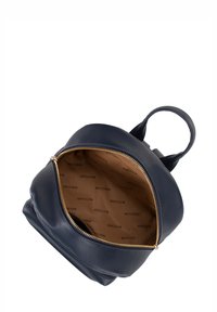 Zaino in pelle blu navy con esterno testurizzato, chiusura con zip dorata e interno beige con un motivo a logos del marchio ripetuto.