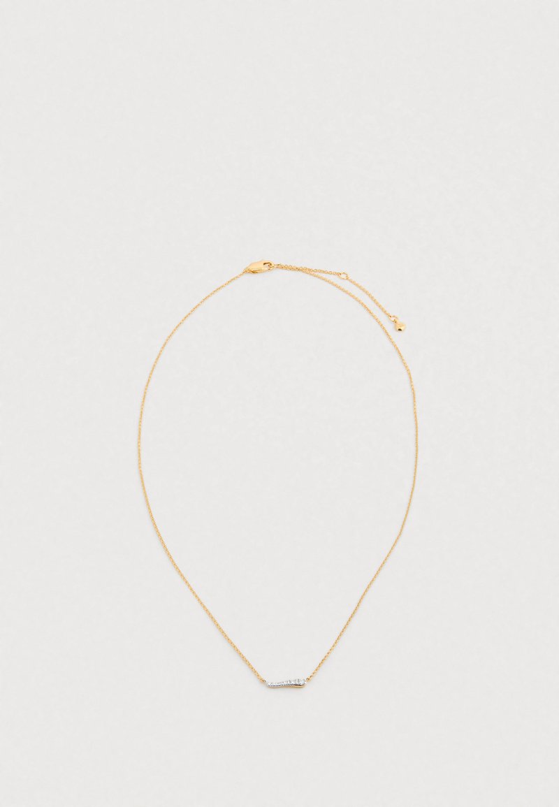 Kuldne kett-kaelakee, millel on peenike horisontaalne riba, millel on hõbedased detailid. Kett koosneb peentest linkidest ja vähikäpp-kinnitusega.