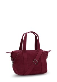 Maroon shoulder bag made of textured fabric, featuring dual short handles, an adjustable strap, and silver-tone hardware with zip closure.