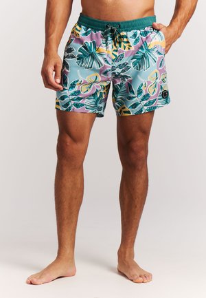Zwembroek met een tropisch bloemenpatroon in teal, paars en geel, voorzien van een elastische tailleband en trekkoorddetail.