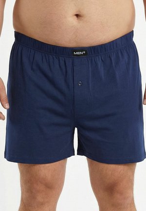 Boxer di cotone blu navy con vita elastica, chiusura frontale con bottoni e dettagli di cuciture minime.