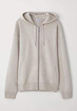 Hellgrauer Reißverschluss-Hoodie aus weichem Material, mit einer Kapuze mit Kordelzug, seitlichen Taschen, gerippten Bündchen und einem kleinen Logo auf der Brust.