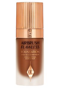 Brown and white foundation bottle with a ribbed gold cap. Features the text "Airbrush Flawless Foundation" in black and gold.