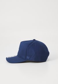 Gorra de béisbol azul marino con una corona estructurada, visera plana, logotipo bordado en el lado y textura de tela. Correa ajustable en la parte posterior.