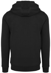 Black hoodie with a kangaroo pocket, ribbed cuffs, and hem. Made of soft fabric, it features a large hood and seamless back design.