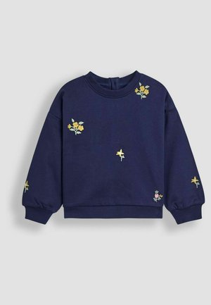 Sudadera de manga larga azul marino con puños acanalados y pequeño bordado floral amarillo y rosa disperso en la parte delantera y las mangas.
