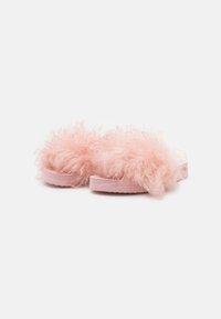 Fuzzy pink slide sandals with a soft, fluffy upper and a pink rubber sole. The design features long, curly texture without visible hardware.