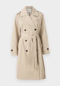 Beige trench coat med dobbelspent knappstenging, beltestropper i midjen, skulderepauleter og sidelommer, laget av et glatt stoff.