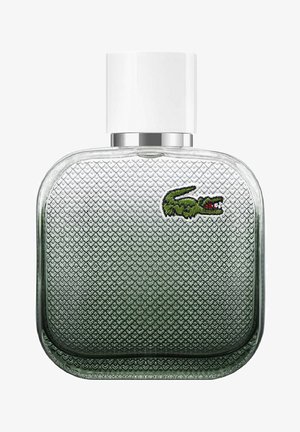 Grön glasparfymflaska med diamantstrukturerad yta, rundade kanter och ett vitt lock. Har en grön broderad krokodil-logotyp.