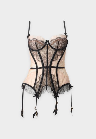 Bustier en dentelle beige et noire avec bretelles réglables, bonnets à armatures, nœuds décoratifs et jarretelles fixées suspendues sous l'ourlet.