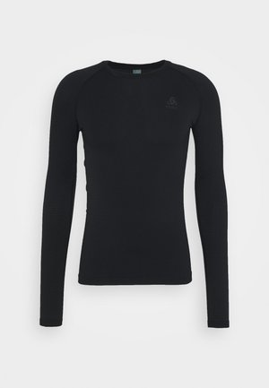 T-shirt thermique noir à manches longues avec un motif texturé, col rond et coupe ajustée. Logo discret sur la poitrine.