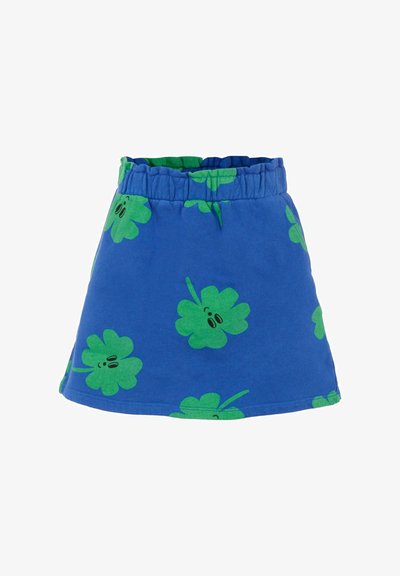 Rock mit elastischem blauen Bund, der grüne Blattmuster zeigt. Der Rock hat ein ausgestelltes Design und eine glatte Textur, geeignet für die Freizeit.