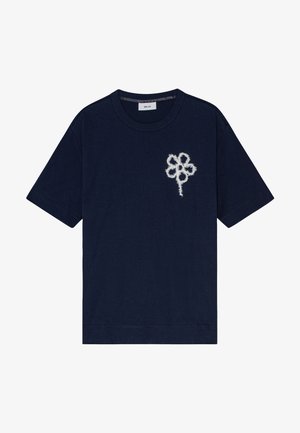 Navy blue cotton t-shirt with a white embroidered flower design on the left chest. Short sleeves and a round neckline. Simple, casual fit.