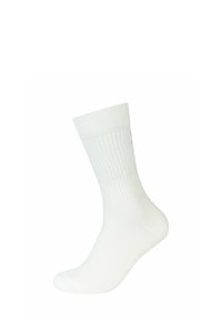 Calzino in cotone bianco con texture a coste, di lunghezza media fino al polpaccio e con minimal branding di colore chiaro sulla parte superiore.
